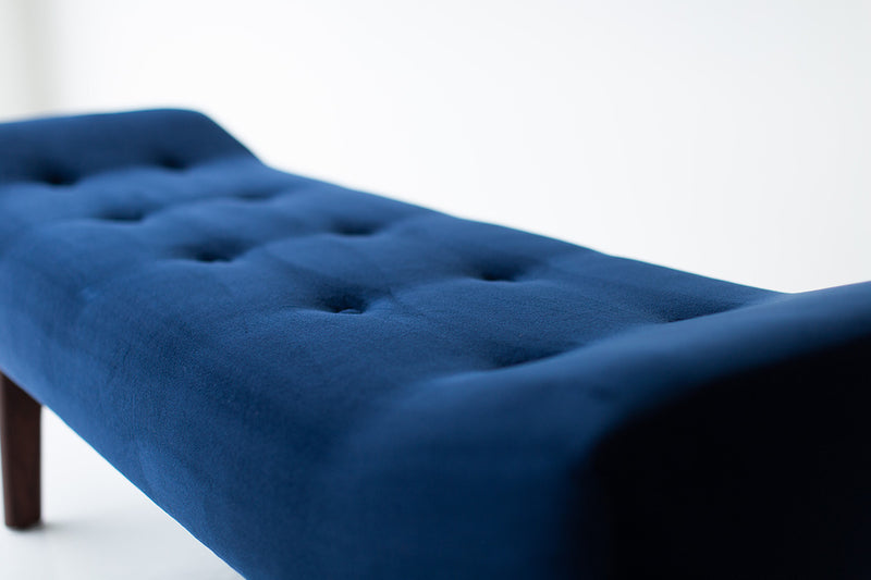Modern luxury Alaska upholstered walnut and oak bench styled at the foot of a bed