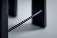 Angled view of a black counter stool showing its commercial grade finish