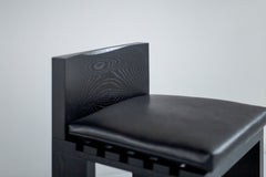 Row of black Chile counter stools styled at a kitchen island