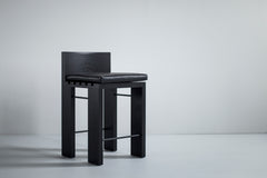 Full view of a black Chile counter stool in black leather against a white backdrop