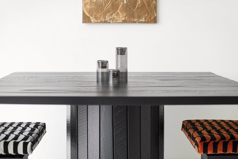 Angled view of a Bellhop dining table showing its black commercial-grade finish