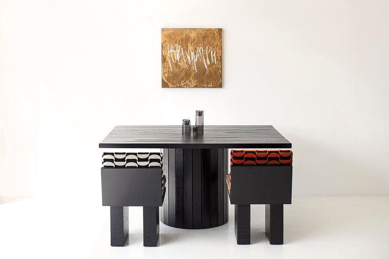 Close-up of the reclaimed wood texture and black finish on a Bellhop table