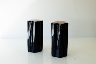 Two black outdoor red cedar stump tables with natural tops