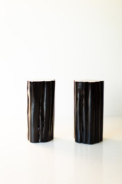 Pair of black outdoor stump tables with natural tops, front view