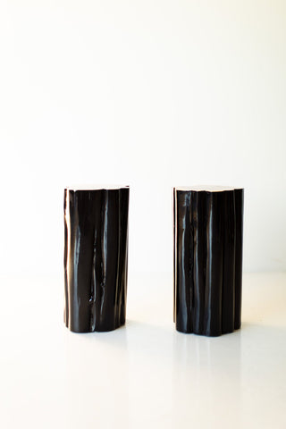 Pair of black outdoor stump tables with natural tops, front view