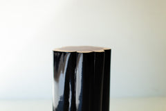 Glossy black outdoor stump table with natural top, close view
