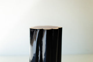 Glossy black outdoor stump table with natural top, close view