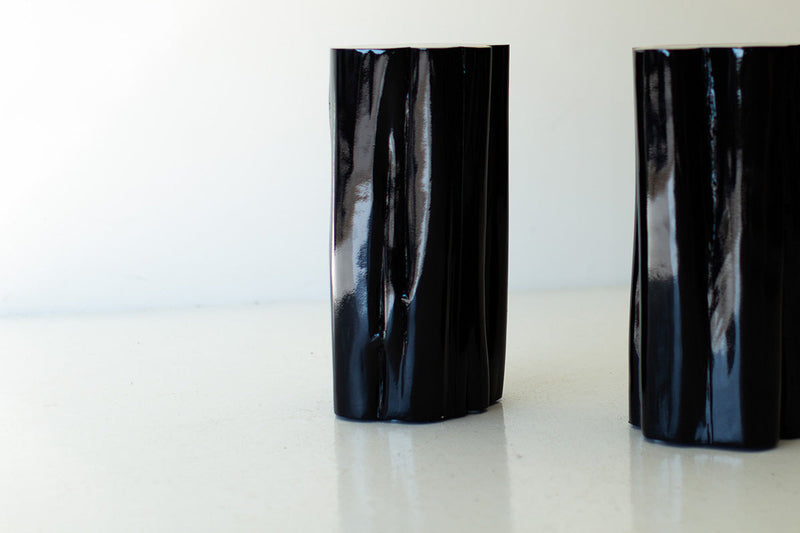 Two black outdoor stump tables with natural tops, close view