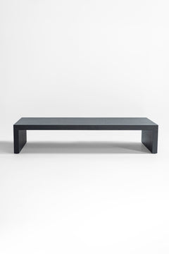 Side profile of a black oak coffee table highlighting its waterfall edge