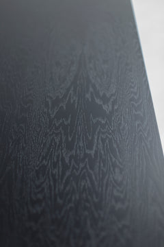 Close-up of the oak wood grain and black commercial-grade finish