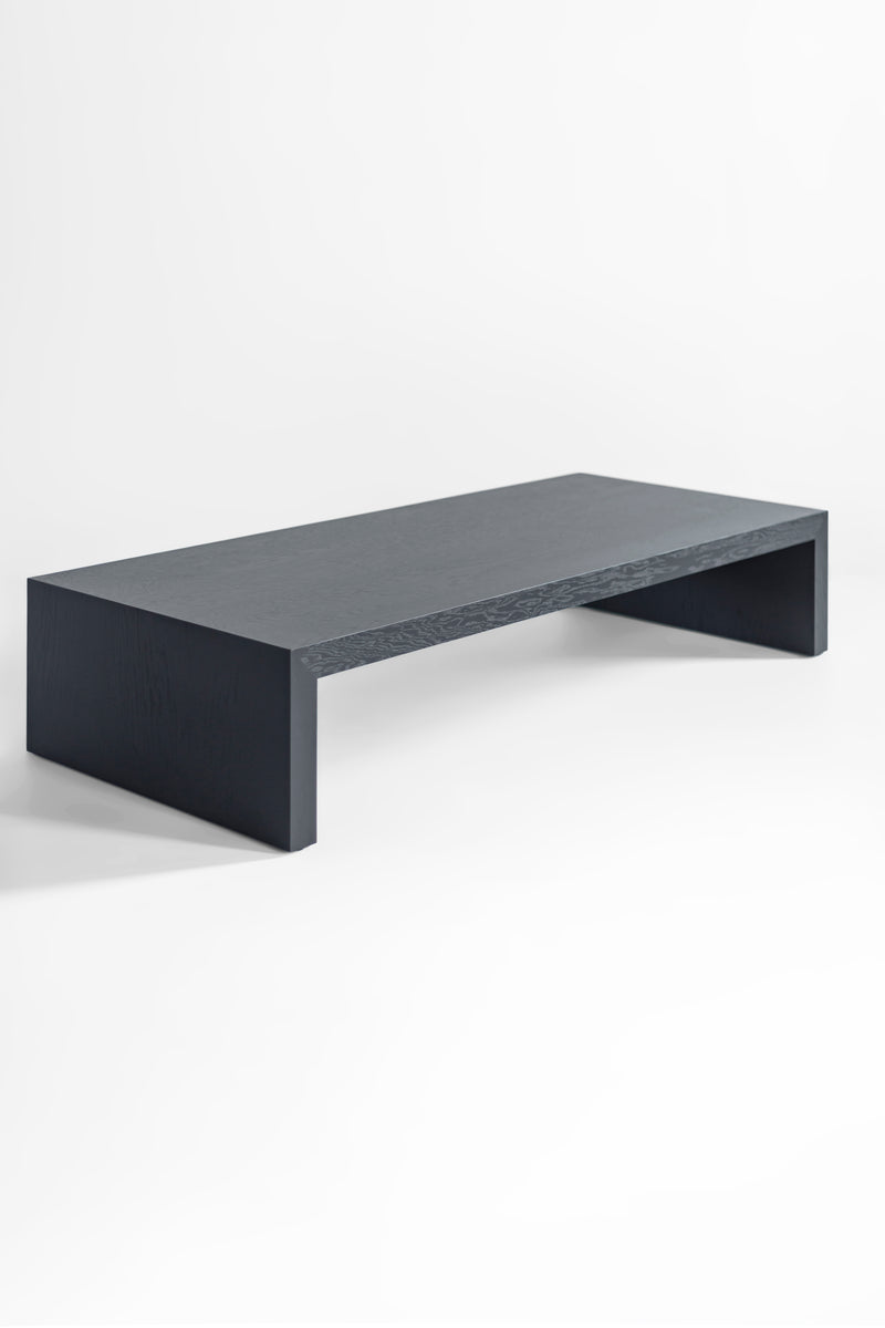Blackened oak coffee table styled with books and decor on top