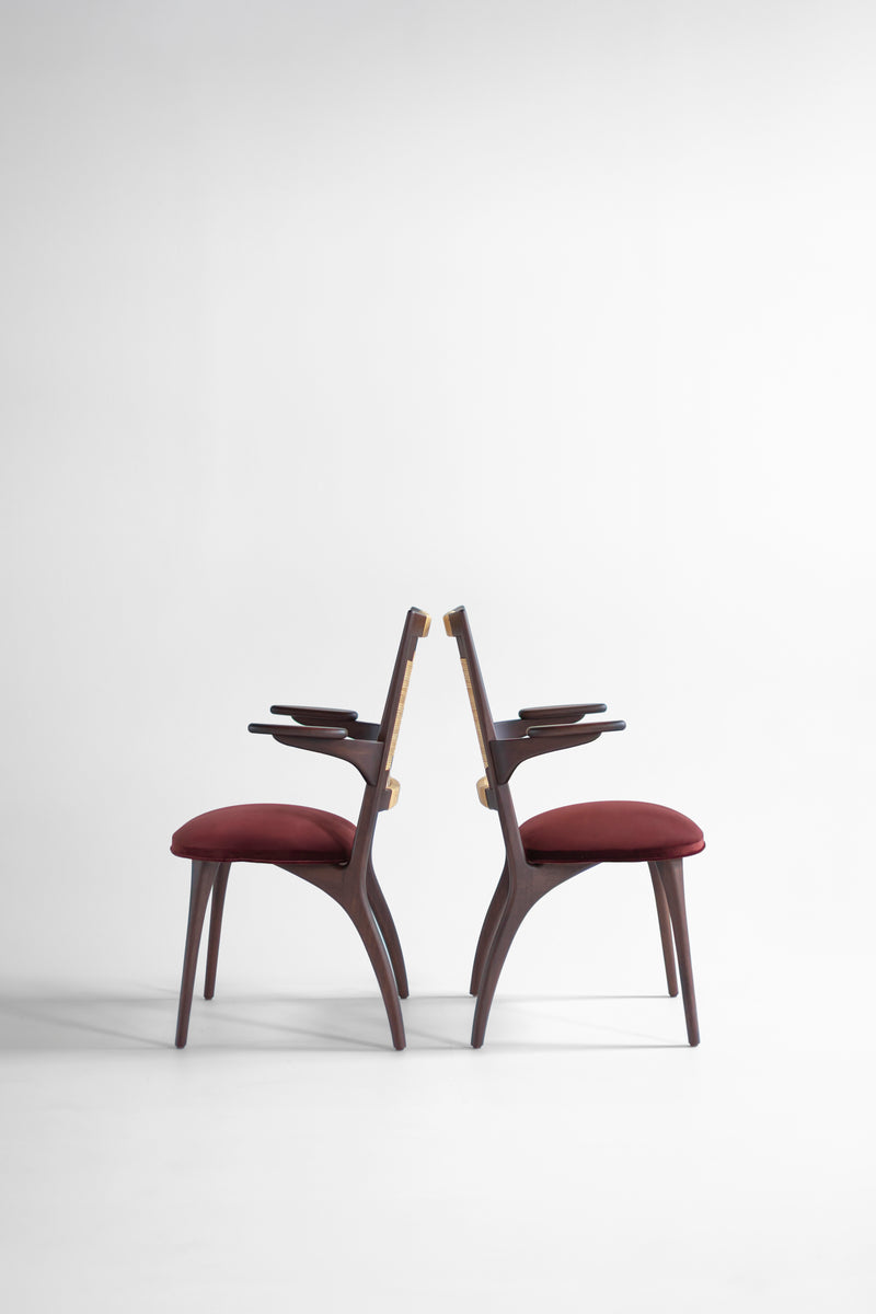 Full view of the modern luxury Bonnie walnut caneback dining arm chair by Craft Associates against a white backdrop