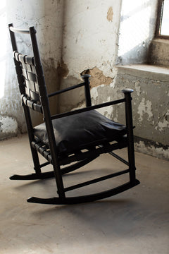 Close-up of the supple black leather seat and back cushions on the modern luxury Catawba rocking chair