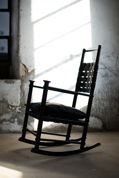 Modern luxury Catawba black leather rocking chair by Craft Associates® styled in a bright interior