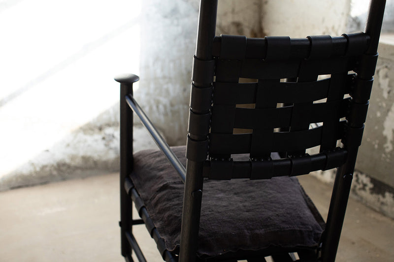 Modern luxury Catawba black leather rocking chair styled in a modern living room