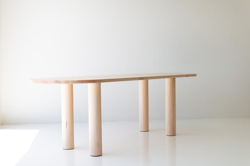 Cava oval dining table styled with modern chairs in a spacious dining room