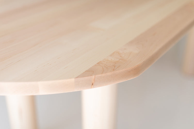 Overhead view of the Cava oval maple dining table