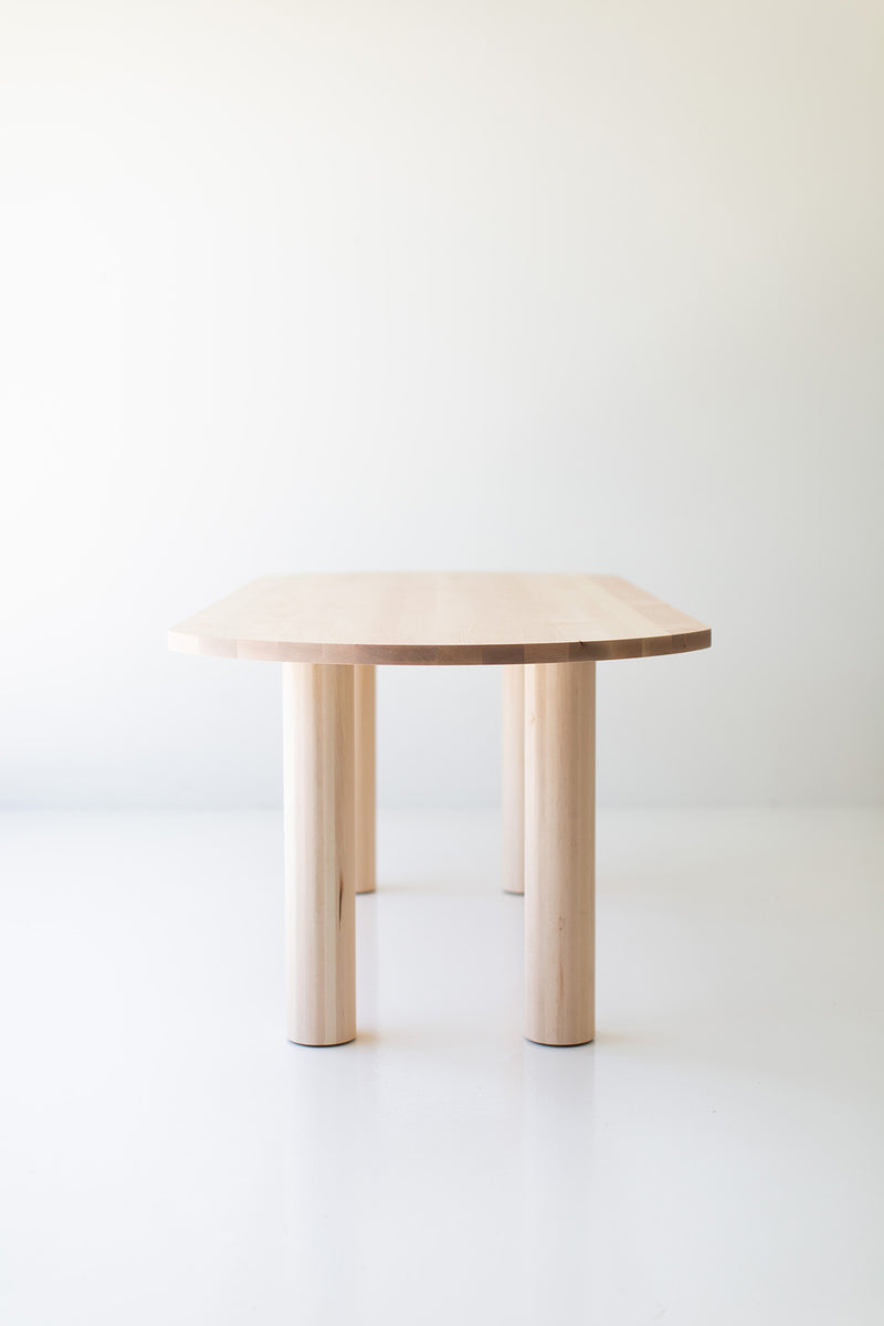 Full view of the Cava oval dining table in a room with natural light