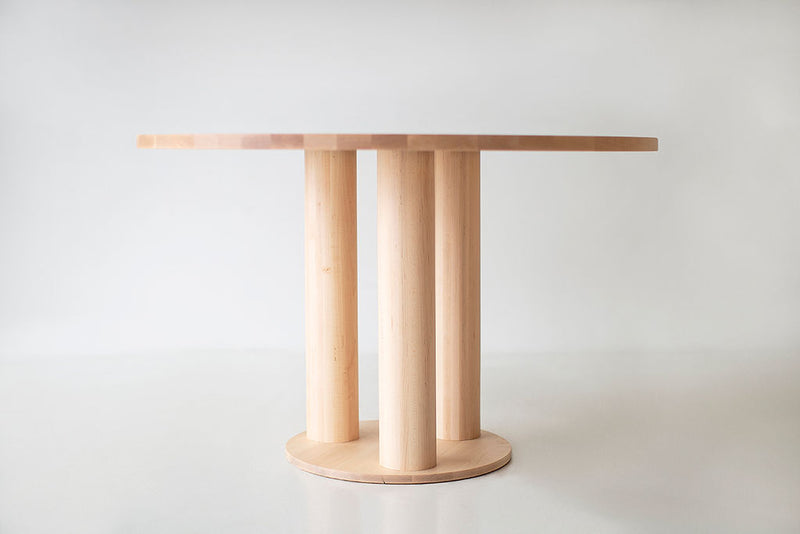 Overhead view of the Cava round maple dining table's smooth tabletop