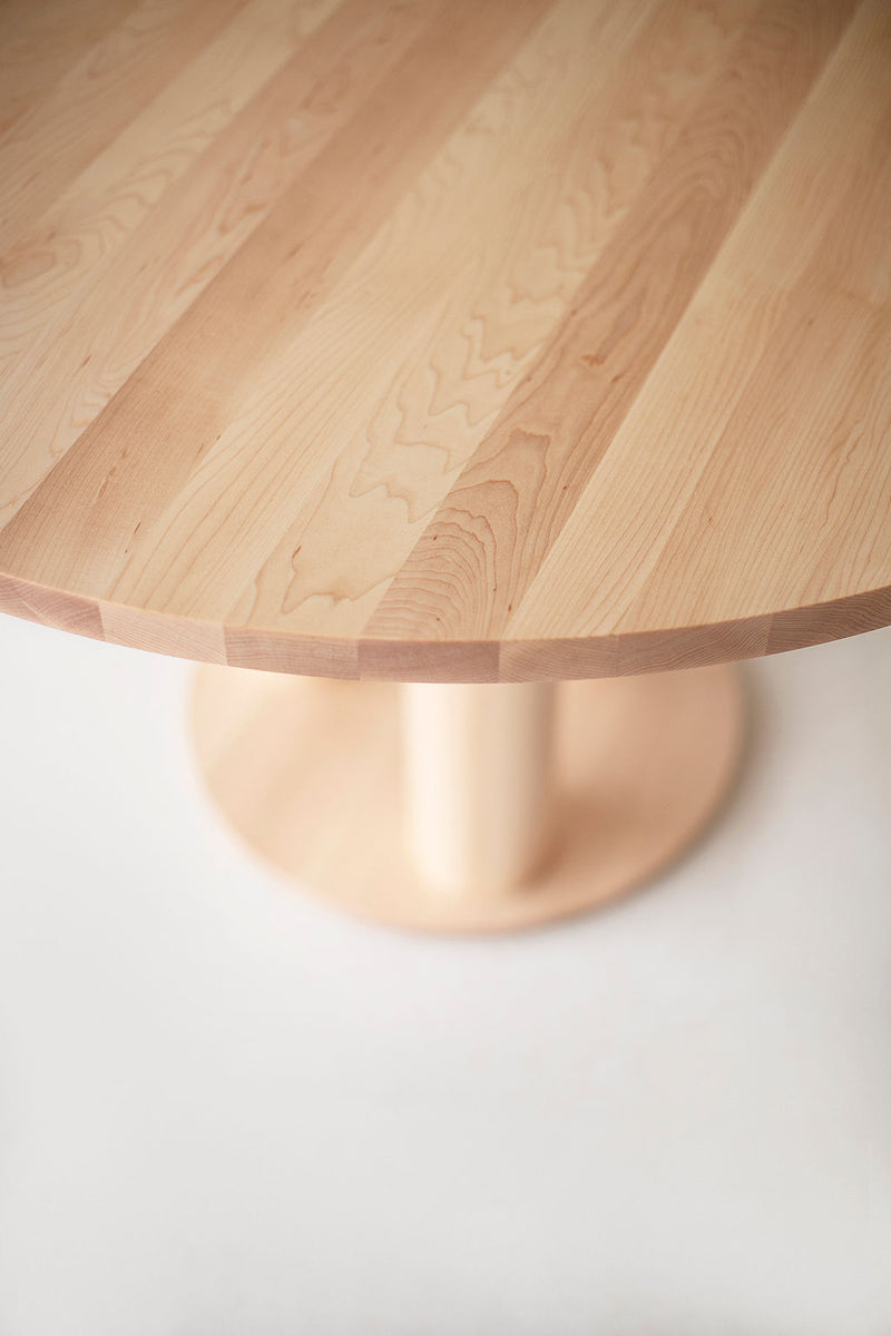 Full room view of the Cava dining table paired with a mix of wood and upholstered chairs