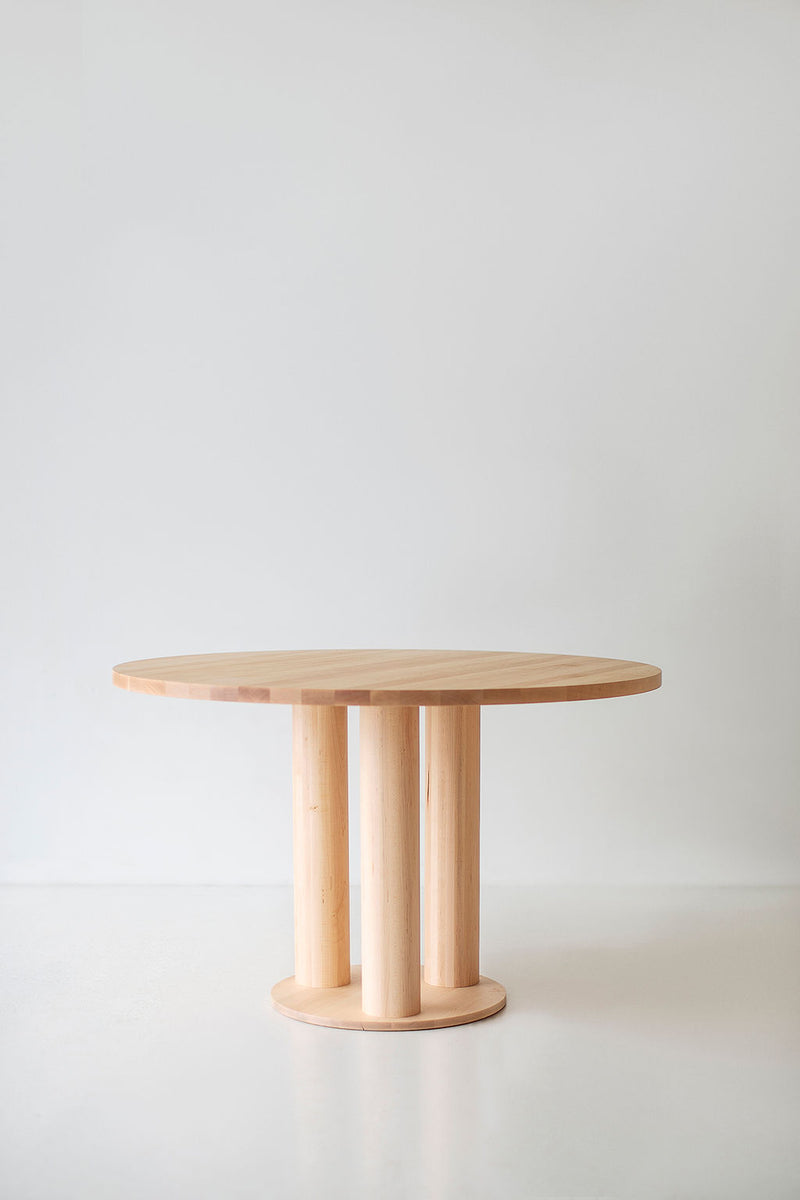 Close-up of the light maple tone and grain pattern on the Cava dining table