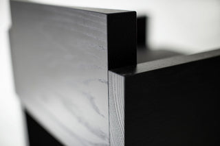 Side profile of a Chile counter stool highlighting its black metal rod frame