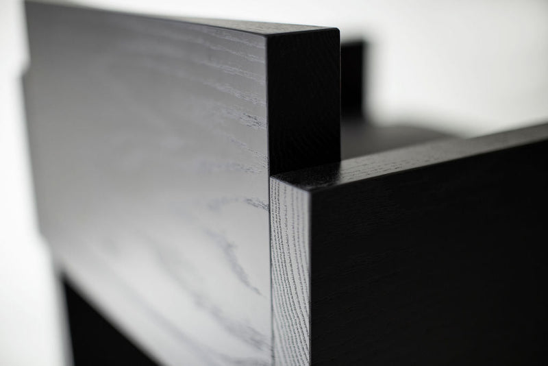 Side profile of a Chile counter stool highlighting its black metal rod frame