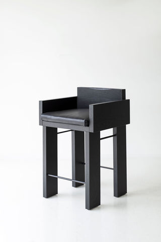 Angled view of a counter stool showing its black commercial grade finish