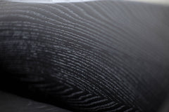 Detail of the oak wood grain and metal joinery on a counter stool