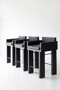 Pair of blackened oak counter stools styled together