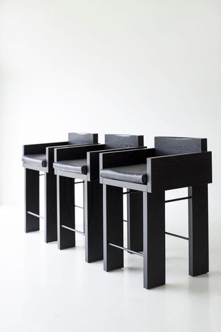 Pair of blackened oak counter stools styled together