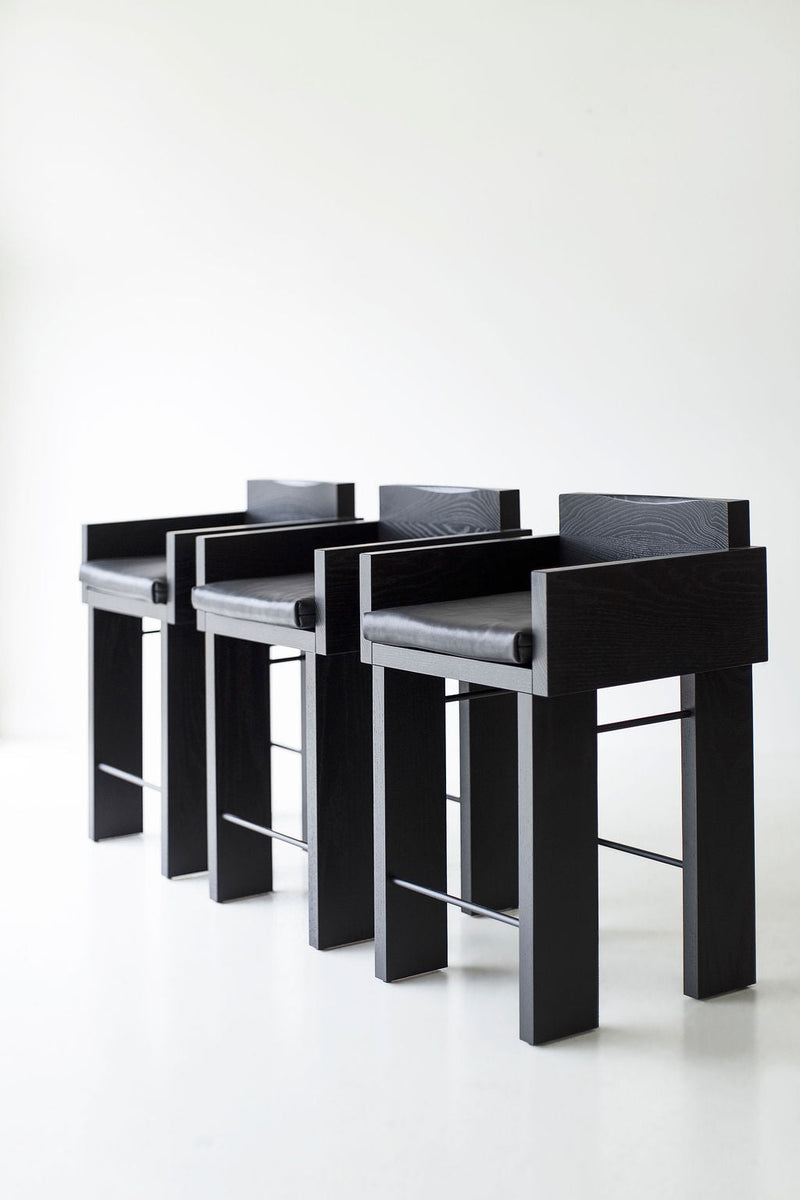 Pair of blackened oak counter stools styled together