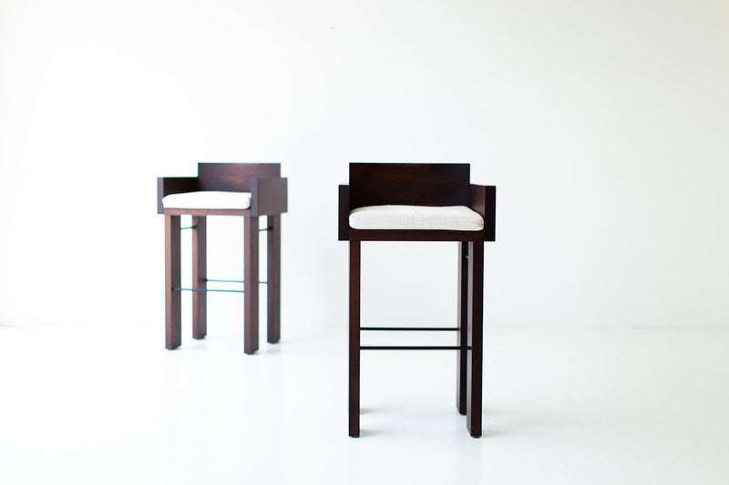 Side profile of the Chile modern bar stool showing its walnut frame and metal rods