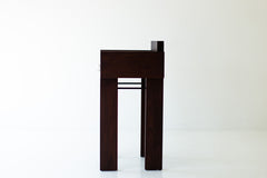 Modern luxury walnut bar stool with arms styled outdoors on a patio