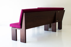 Three-quarter view of the walnut banquette and its solid wood frame