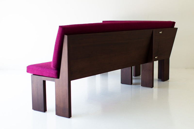 Three-quarter view of the walnut banquette and its solid wood frame