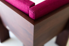 Modern walnut banquette paired with a dining table in a full room view