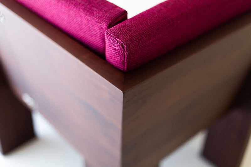 Modern walnut banquette paired with a dining table in a full room view