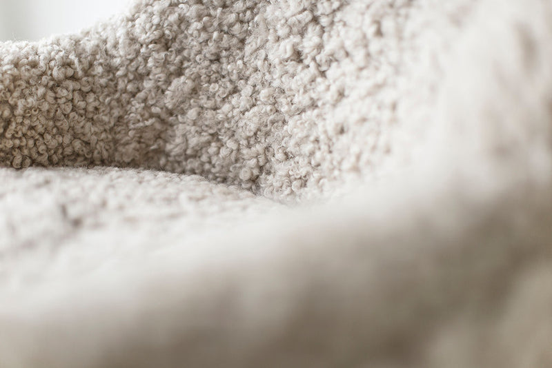 Front view of the modern luxury Nantucket lounge chair showing its shearling upholstery
