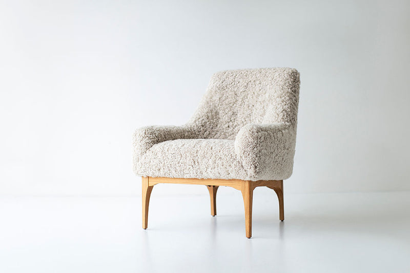 Side profile of the modern luxury Nantucket shearling lounge chair highlighting its oak frame