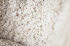 Detail of the solid oak frame and joinery on the modern luxury Nantucket shearling lounge chair