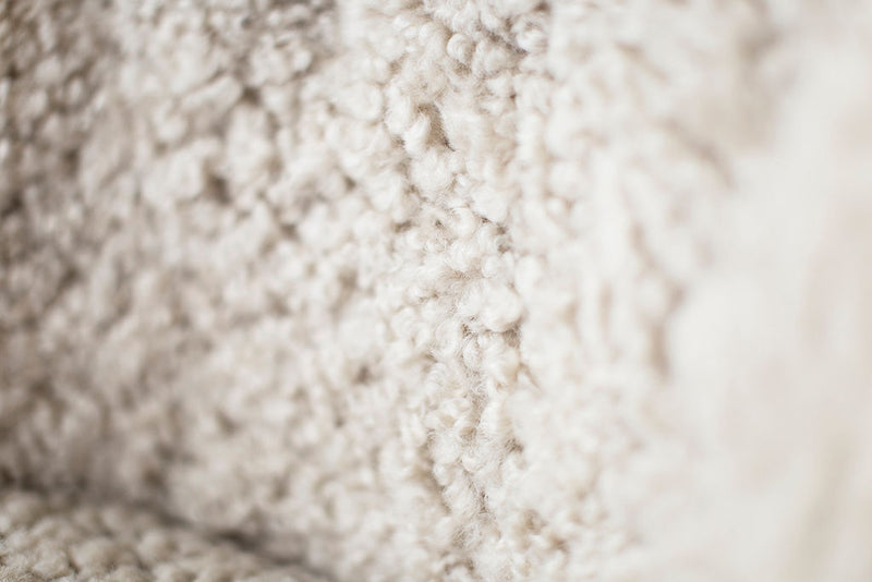 Detail of the solid oak frame and joinery on the modern luxury Nantucket shearling lounge chair