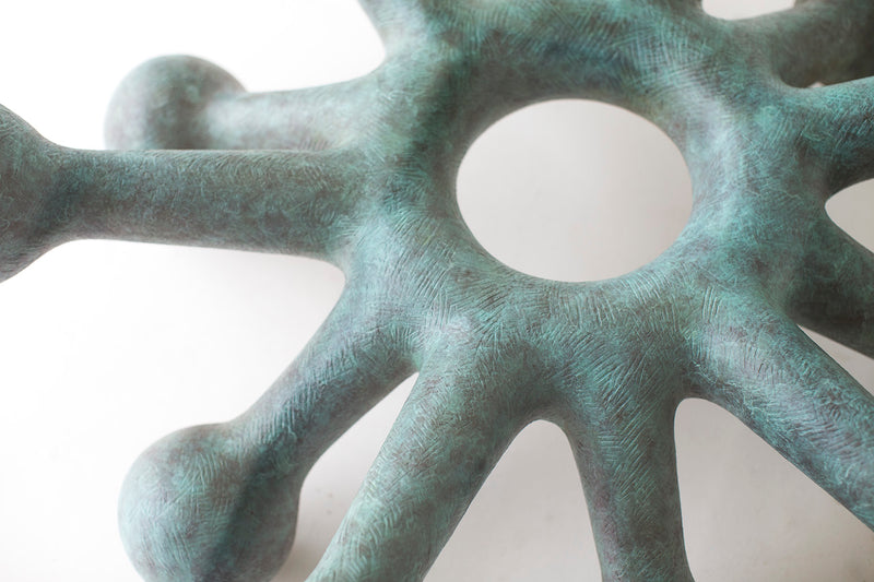 Modern bronze coffee table styled in a living room setting