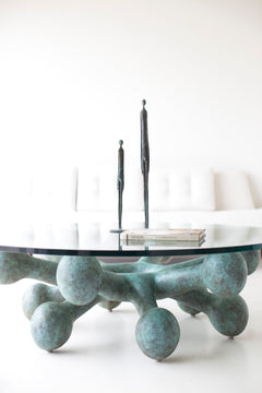 Modern bronze and glass coffee table in a mid-century living room