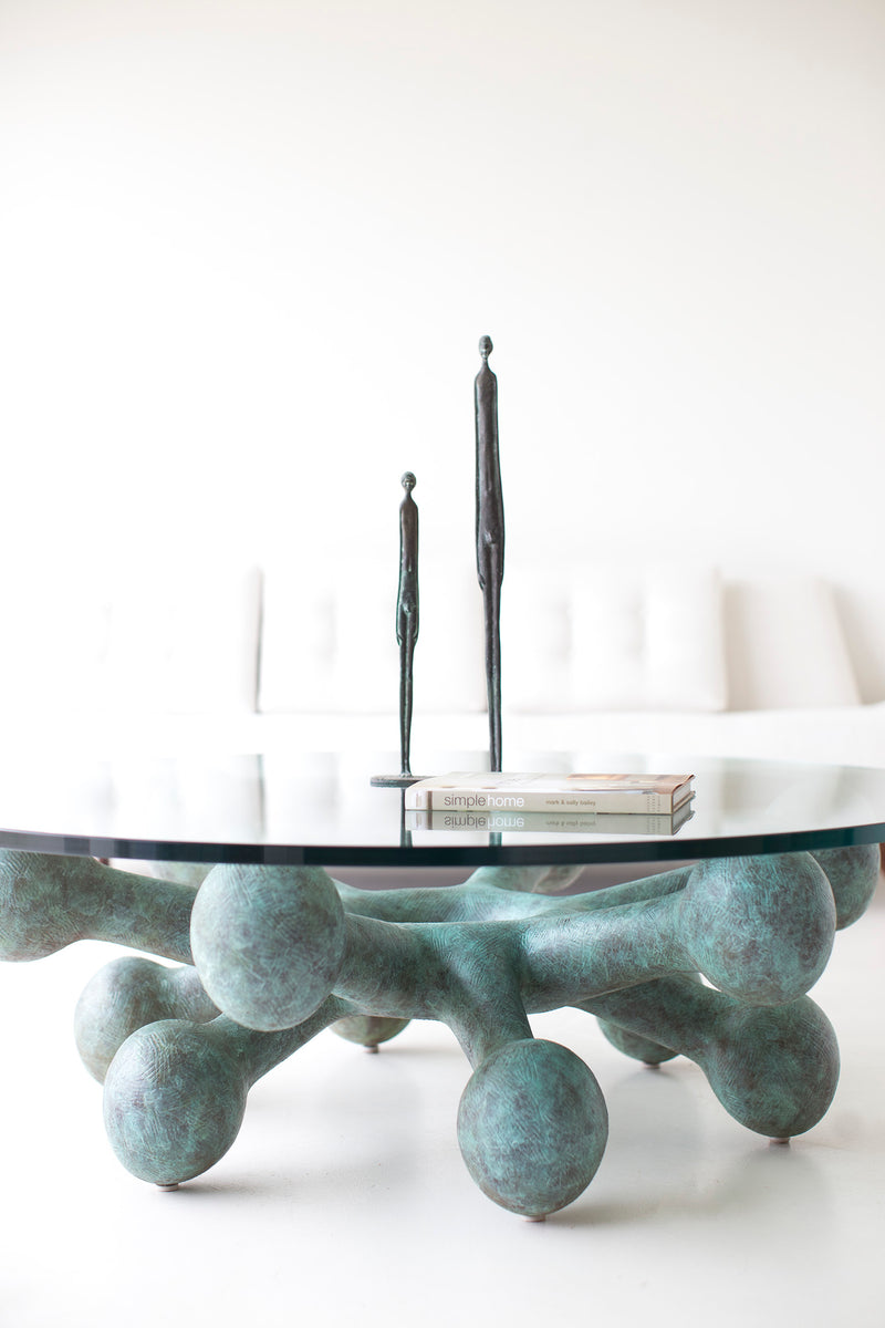 Modern bronze and glass coffee table in a mid-century living room