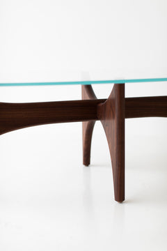 Craft Associates oval coffee table showing hand-shaped teak legs