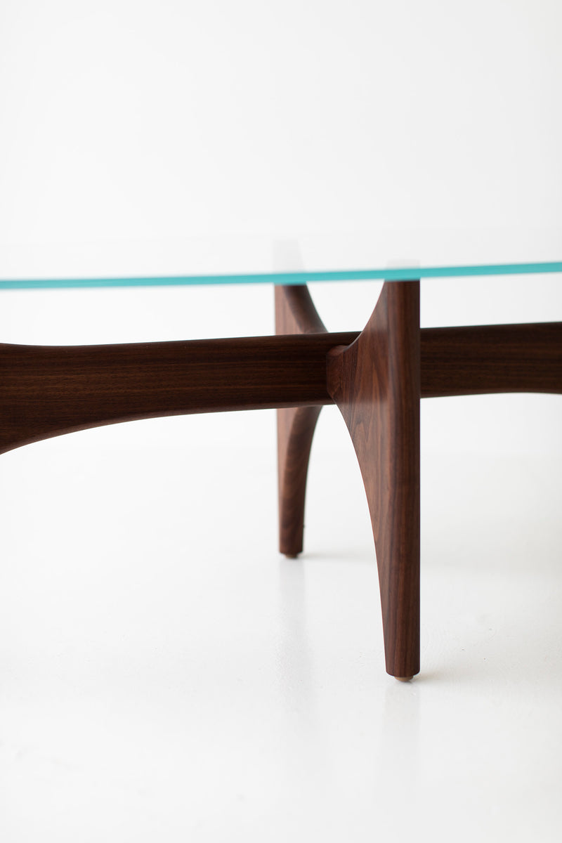 Craft Associates oval coffee table showing hand-shaped teak legs