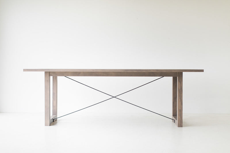 Modern luxury distressed grey dining table styled in a dining room