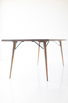 The New York modern dining table styled with chairs in a dining room