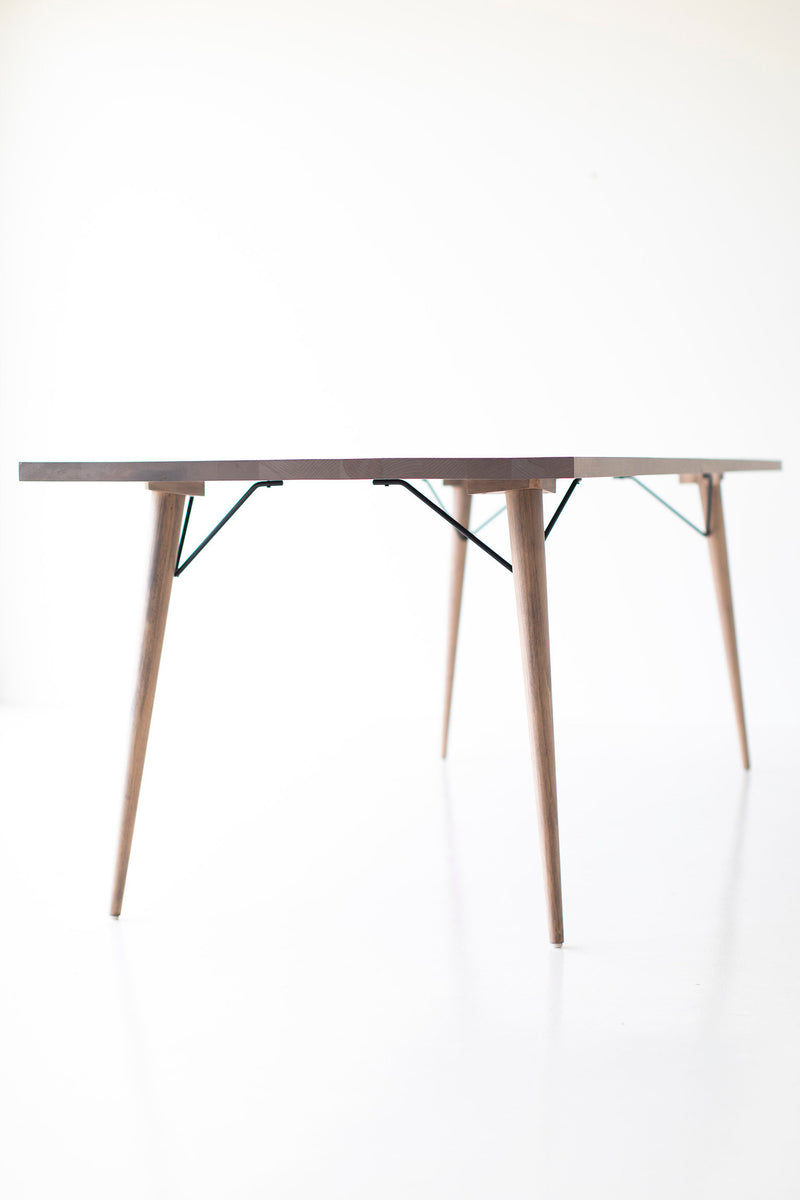 The New York modern dining table styled with chairs in a dining room